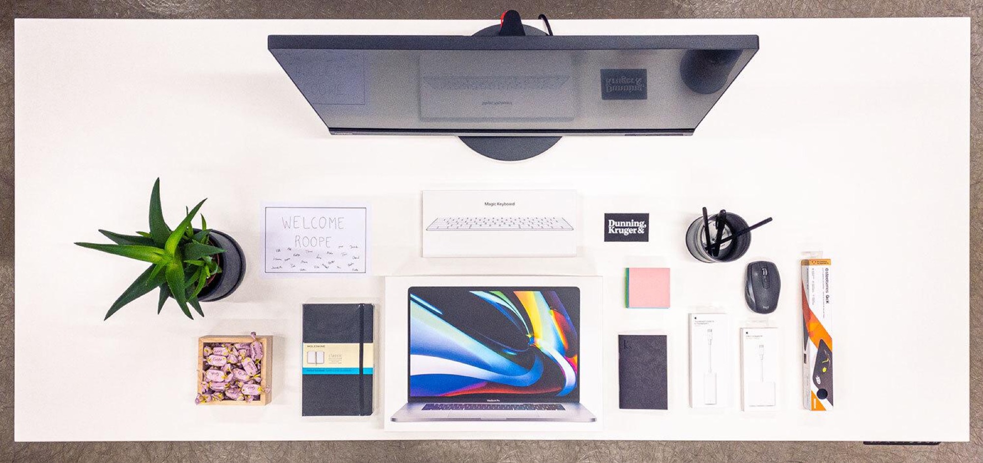 View from above a designer workspace with monitor and desk.